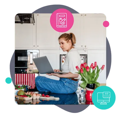 an image of a food blogger sitting on the kitchen counter looking at her computer