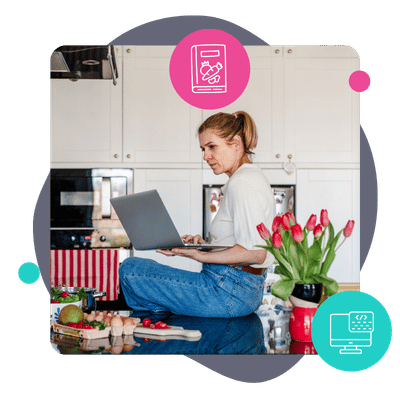 an image of a food blogger sitting on the kitchen counter looking at her computer
